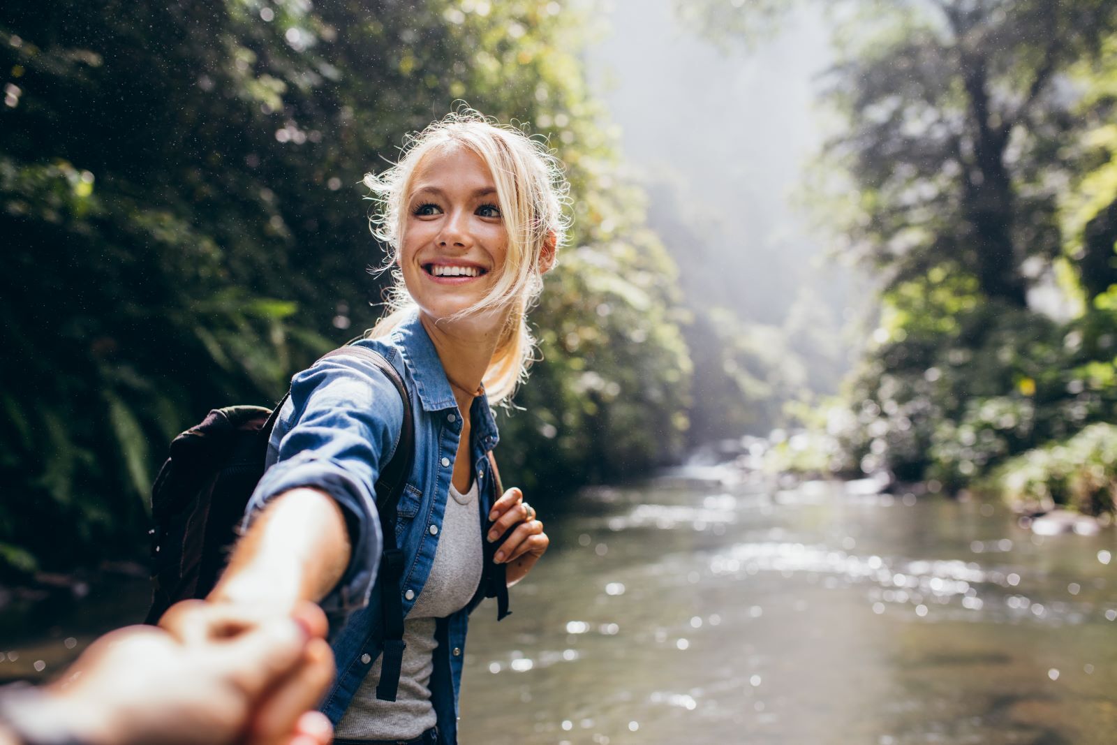 woman hiking along river